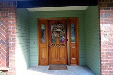 Mid-sized arts and crafts green two-story mixed siding exterior home photo in Seattle with a hip roof