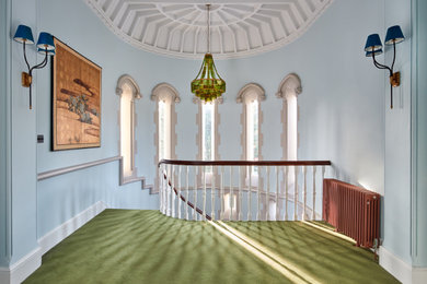 Inspiration for a large timeless carpeted, green floor and coffered ceiling hallway remodel in London with blue walls