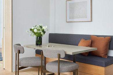 Inspiration for a small contemporary light wood floor dining room remodel in New York with white walls and no fireplace
