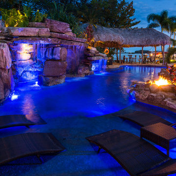 Custom Rock Waterfall Pool with Stone Grotto, Stream and Tiki Hut