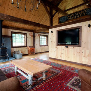 Large traditional open plan home cinema in Manchester with light hardwood flooring and a built-in media unit.