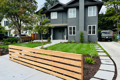 This is an example of a mid-sized contemporary partial sun front yard concrete paver and wood fence landscaping in San Francisco.