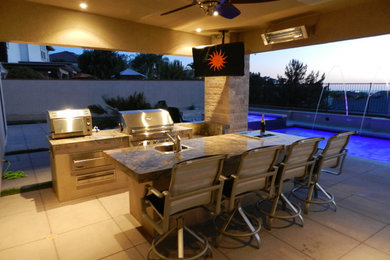 Inspiration for a large timeless backyard concrete paver patio fountain remodel in Orange County