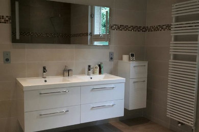 This is an example of a contemporary 3/4 bathroom in Paris with beige tile, ceramic tile, beige walls, ceramic floors, a trough sink and tile benchtops.