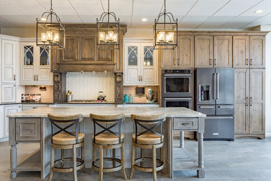 Open concept kitchen - large transitional l-shaped gray floor open concept kitchen idea in Other with an island, shaker cabinets, medium tone wood cabinets, white backsplash, stainless steel appliances, granite countertops and subway tile backsplash