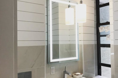 Inspiration for a small contemporary 3/4 gray tile and porcelain tile bathroom remodel in New York with black cabinets, white walls, an integrated sink, quartz countertops and white countertops