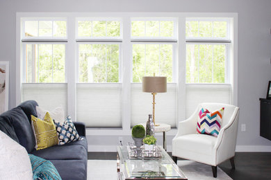 Inspiration for a mid-sized contemporary enclosed dark wood floor and brown floor living room remodel in Cedar Rapids with gray walls and no fireplace