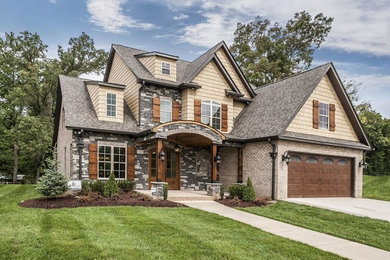 Example of a mid-sized arts and crafts two-story mixed siding exterior home design in Other