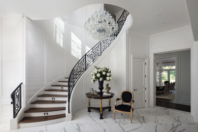 Mid-sized elegant wooden curved metal railing staircase photo in San Francisco with wooden risers
