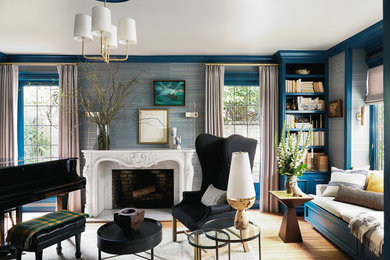 Living room - mid-sized transitional medium tone wood floor and wallpaper living room idea in San Francisco with a music area, blue walls, a standard fireplace and a stone fireplace