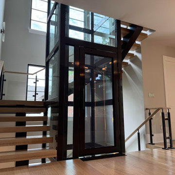 Project #136 | Modern Floating Staircase Encircling Glass Elevator