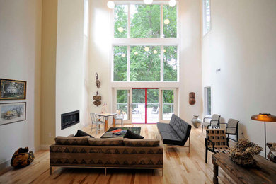 Mid-sized formal and open concept light wood floor and beige floor living room photo in Philadelphia with white walls, a ribbon fireplace, a plaster fireplace and no tv