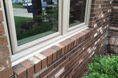 Vinyl replacement windows in brick wall - after