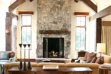 Large mountain style open concept living room photo in Denver with beige walls, a standard fireplace, a stone fireplace and no tv