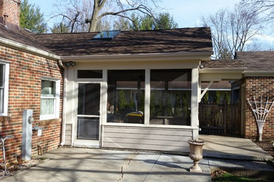 Mid-sized classic tile screened-in back porch idea in Chicago with a roof extension
