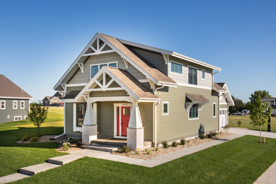 Inspiration for a mid-sized craftsman green two-story concrete fiberboard exterior home remodel in Other with a shed roof