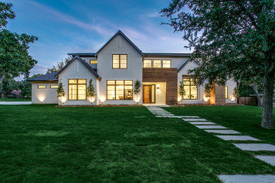 Example of a large minimalist beige two-story wood and clapboard exterior home design in Dallas with a mixed material roof and a black roof