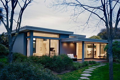Example of a mid-sized minimalist gray one-story glass flat roof design in New York