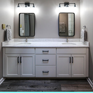 All White Bathroom with Black Hardware and Gray Flooring