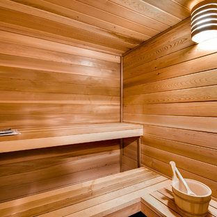 Expansive traditional look-out basement in Denver with beige walls, carpet, no fireplace and beige floors.