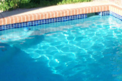 Inspiration for a backyard brick and rectangular pool remodel in Chicago