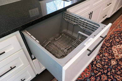 Small transitional galley kitchen photo in Other with shaker cabinets, white cabinets, granite countertops, gray backsplash, ceramic backsplash, paneled appliances and black countertops