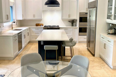 Example of a large classic u-shaped marble floor and beige floor kitchen design in Toronto with an undermount sink, recessed-panel cabinets, white cabinets, quartz countertops, white backsplash, quartz backsplash, stainless steel appliances, an island and white countertops