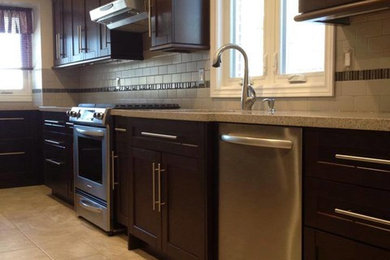 Mid-sized elegant l-shaped ceramic tile eat-in kitchen photo in Toronto with an undermount sink, shaker cabinets, dark wood cabinets, granite countertops, beige backsplash, ceramic backsplash and stainless steel appliances