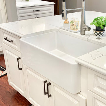 Ivory White Kitchen With Marble Look Quartz Counters and Splash