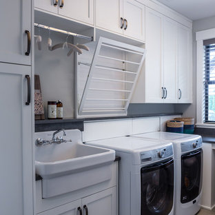 Design ideas for a traditional l-shaped separated utility room in Portland with shaker cabinets, white cabinets, grey walls, a side by side washer and dryer, grey floors, grey worktops and a built-in sink.