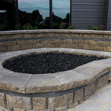 Tear Drop Fire Pit With Flowers and Foundation Wall