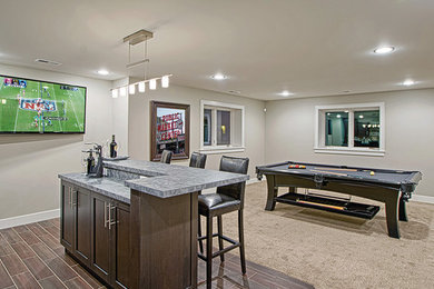 Example of a mid-sized trendy look-out carpeted and beige floor basement design in Other with black walls