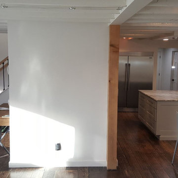 Modernize old two story home, expand over existing garage