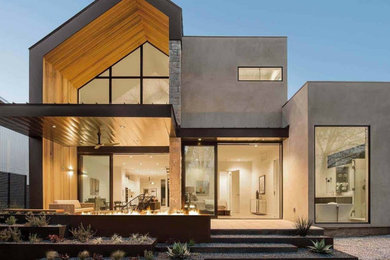 Foto de fachada de casa gris minimalista grande de dos plantas con revestimiento de hormigón y tejado plano