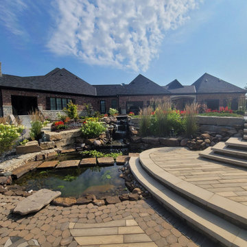 Estate Poolside Landscape & Hardscape Retreat with Custom Waterfeature