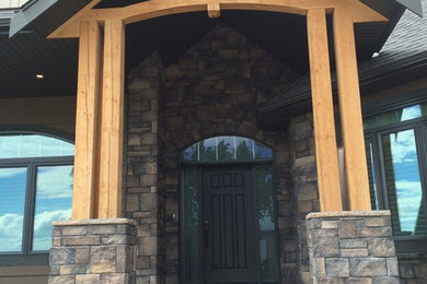 Inspiration for a mid-sized craftsman brown one-story mixed siding gable roof remodel in Calgary