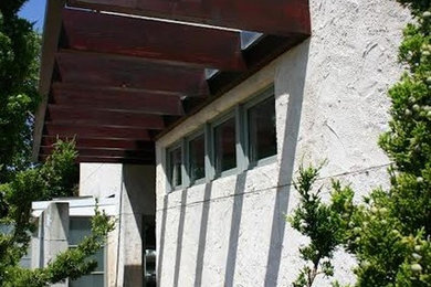 Large modern gray three-story mixed siding exterior home idea in New York