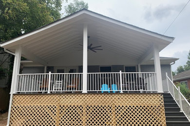 Large transitional metal railing porch idea in Charlotte with decking and a roof extension
