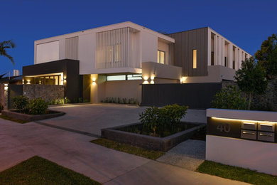 Example of a trendy home design design in Gold Coast - Tweed