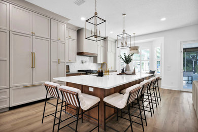 Inspiration for a large coastal open concept kitchen remodel in Jacksonville with shaker cabinets, quartz countertops, white backsplash, paneled appliances, an island and white countertops