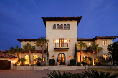 Huge tuscan white three-story stucco house exterior photo in Austin with a hip roof and a tile roof