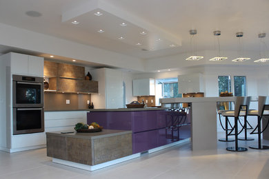 Example of a large trendy ceramic tile kitchen design in San Francisco with an undermount sink, white cabinets, quartz countertops, brown backsplash, stone slab backsplash, paneled appliances and an island