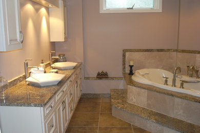 Large transitional master porcelain tile and brown floor bathroom photo in Toronto with beige walls, a vessel sink, granite countertops, beaded inset cabinets and white cabinets
