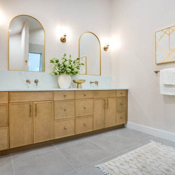 White Oak Double Vanity with Arched Brass Mirrors and Wall Faucets – Bothell