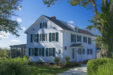 Example of a large classic white three-story wood exterior home design in Other with a shingle roof