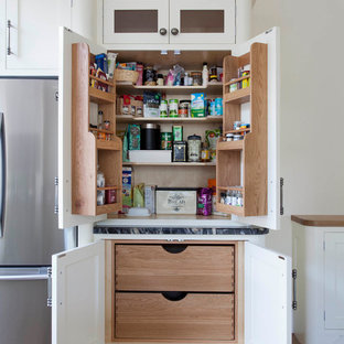 Farmhouse kitchen pantry ideas - Kitchen pantry - farmhouse light wood floor and brown floor kitchen pantry idea in Belfast with stainless steel appliances, shaker cabinets and white cabinets