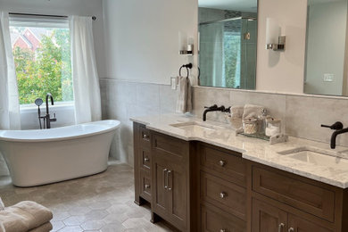 Inspiration for a large transitional master gray tile and porcelain tile porcelain tile, gray floor and double-sink bathroom remodel in Cincinnati with medium tone wood cabinets, white walls, an undermount sink, quartz countertops and a built-in vanity