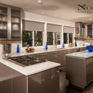 Large contemporary kitchen pantry designs - Large trendy u-shaped dark wood floor kitchen pantry photo in New Orleans with an undermount sink, flat-panel cabinets, gray cabinets, granite countertops, stainless steel appliances, two islands, white backsplash and glass tile backsplash