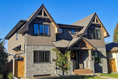 Large craftsman brown two-story stucco exterior home idea in Calgary with a shingle roof and a gray roof