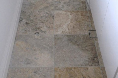 This is an example of a laundry room in Sydney with travertine floors.